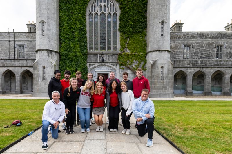 UGA students and professors pose for a group photo with Des Ryan, director of sport and physical well-being, at the University of Galway.